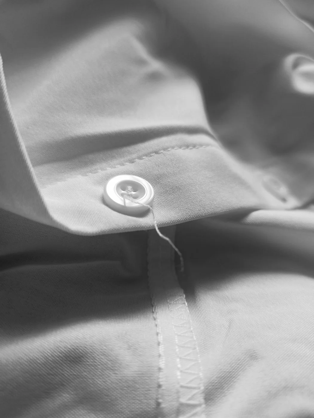 White shirt fabric with a button and folded cuff