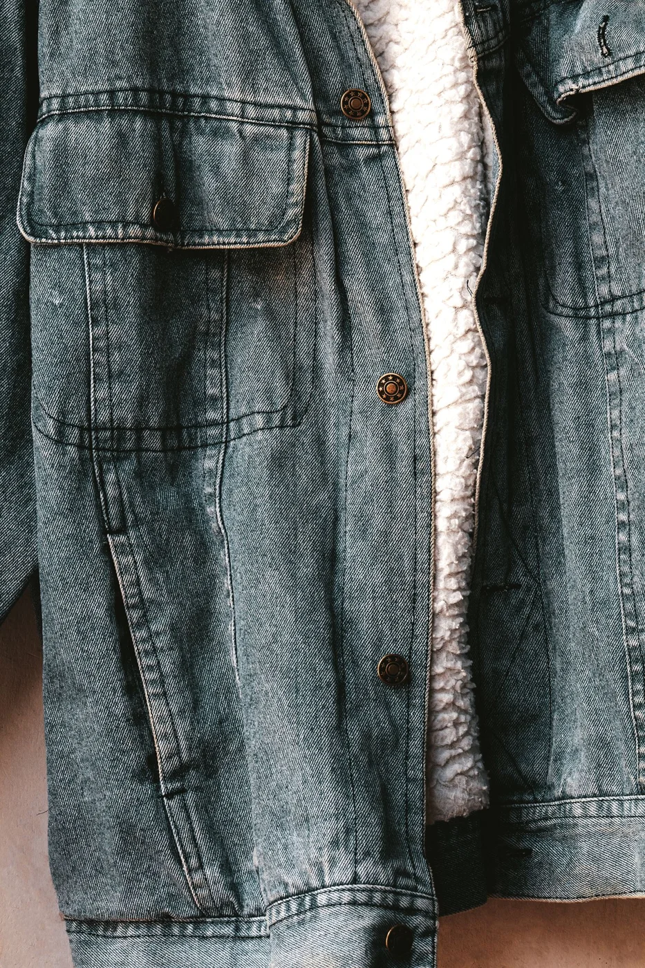 Close view of a denim jacket front and pocket