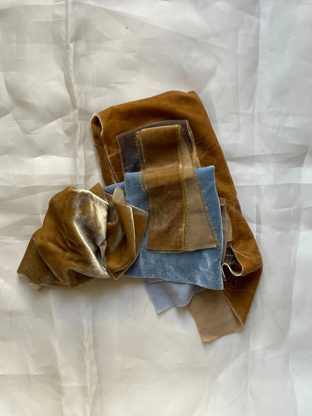 Velvet fabric swatches on a pale surface