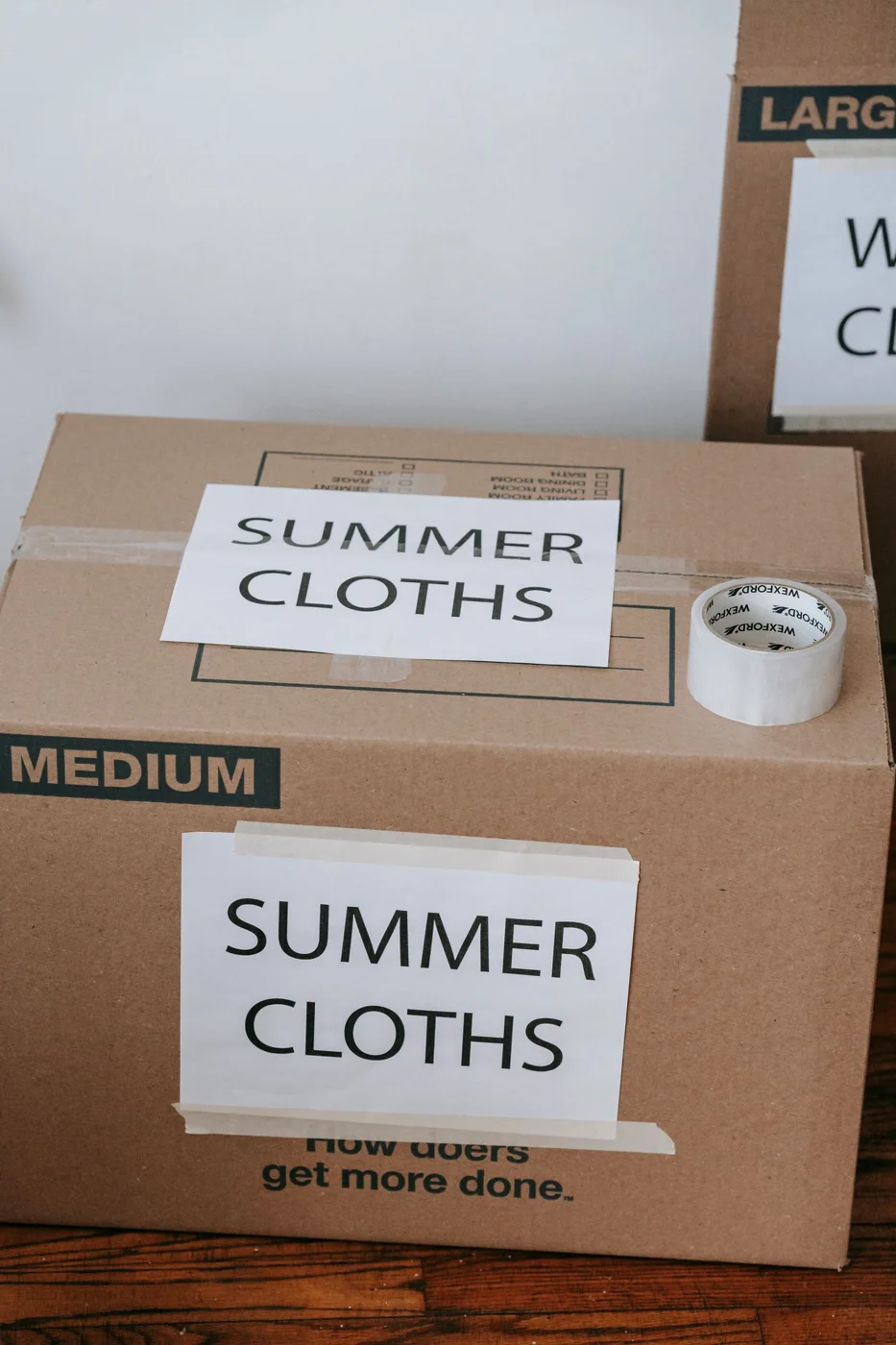 Seasonal clothing packed in a labeled storage box